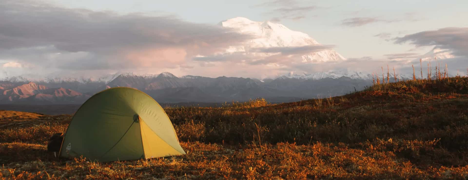 Tent in front of a mountain panorama