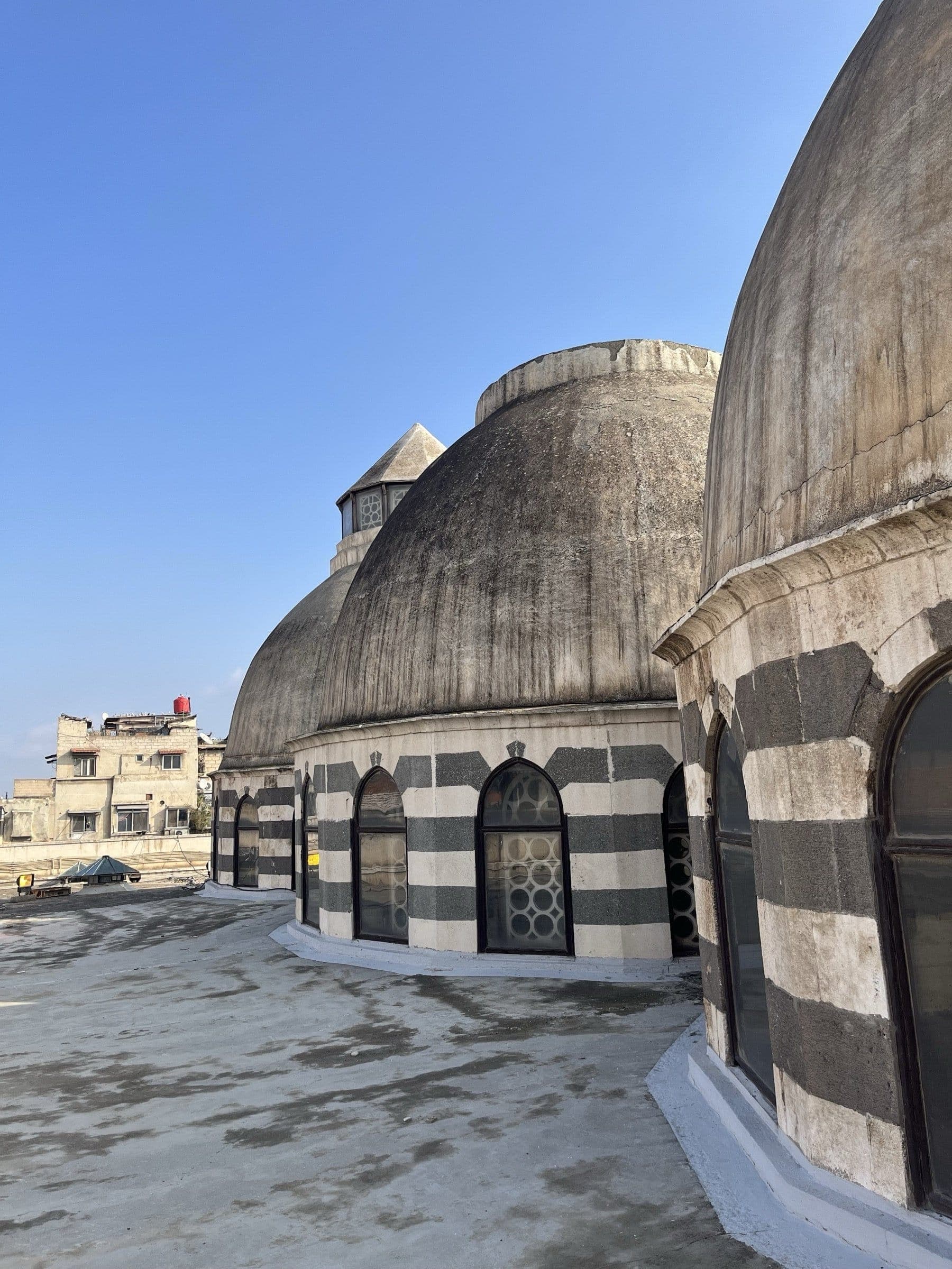 Historic mosque with black-and-white striped domes in the old town of Damascus