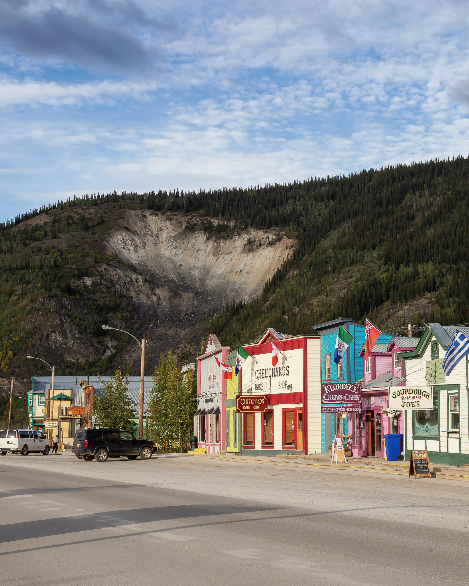 Dawson City, Yukon, Canada - August 27, 2020: Colorful Historic Buidings in a small touristic town during a cloudy summer day.